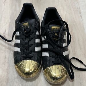 Adidas Black and Gold Superstars Sneakers